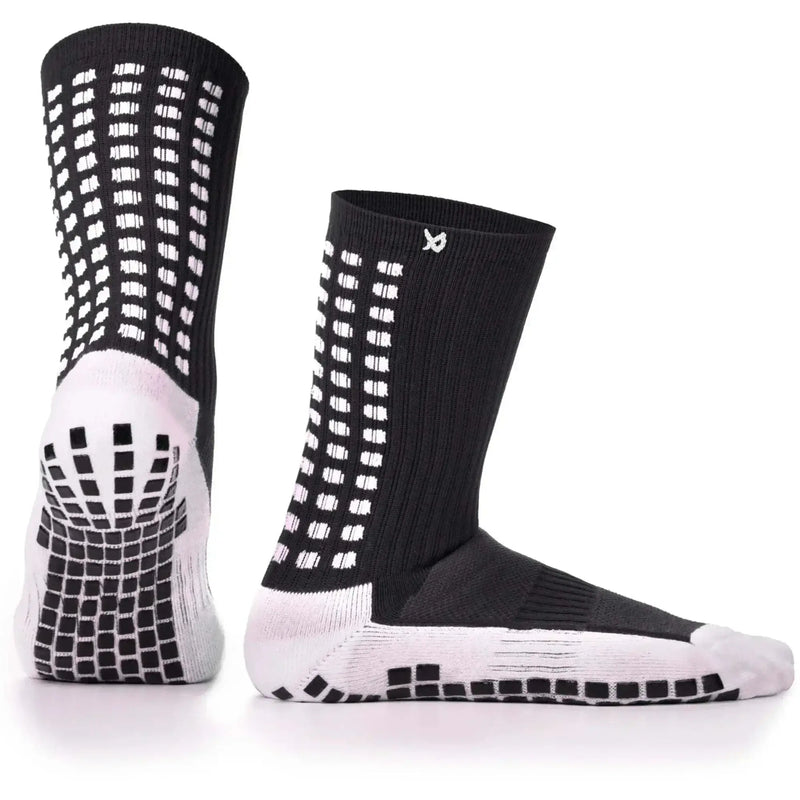Black and white anti-slip football grip socks with dual grip technology for enhanced stability and performance.