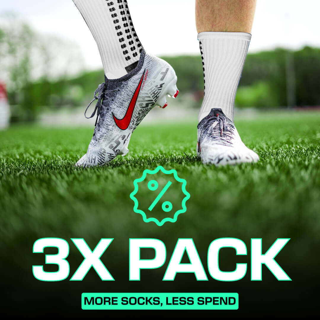 Multipack of white LUX grip socks football with anti-slip technology worn with cleats on grass field
