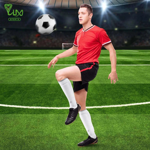 Football player wearing LUX Football Sleeves in white, enhancing performance with compression and secure fit on the field.