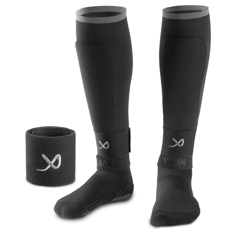 Black LUX football sleeves with compression and silicone grip for shin guard support.