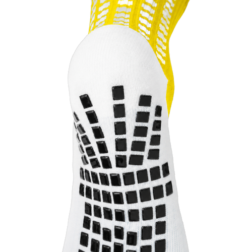 Back and heel grip detail on the yellow LUX V1 grip sock